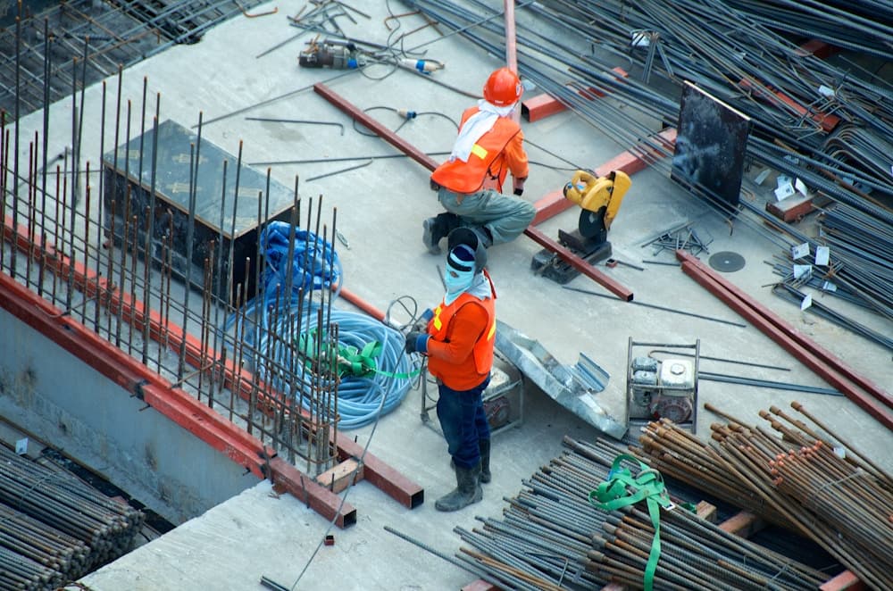 Construction workers preparing reinforcement at a building site
